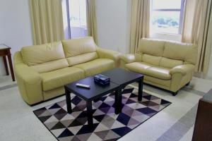 Sala de estar con 2 sofás y mesa de centro en D’lina pelangi, en Kampong Kemaman