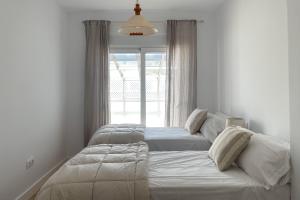 A bed or beds in a room at INFINITY Sunny Home by Cadiz4Rentals