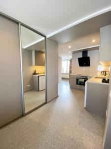 a large mirror in a room with a kitchen at Apartments in Dobele city center - Pilsētas Māja in Dobele +13 photos