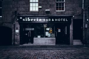 a brick building with a sign on the side of it at Siberia Bar & Hotel in Aberdeen