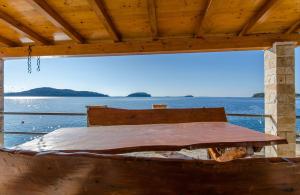 a bed on a boat with a view of the water at Apartments Ivan in Prizba