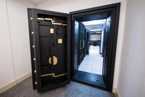 a black door with a mirror in a hallway at The Gold Bank in Prague