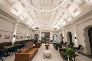 a lobby with couches and tables and a ceiling at The Gold Bank in Prague