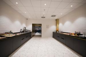 a large kitchen with long counters and a hallway at The Gold Bank in Prague
