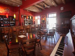 a restaurant with tables and chairs and a piano at KAROO ART HOTEL 4 Star in Barrydale +9 photos