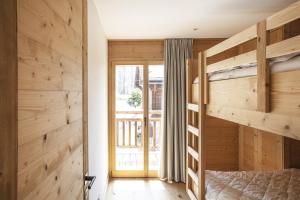 a bedroom with wooden walls and a bunk bed at Polaris 1 005 - LUXE & SKI LIFT apartment 6 pers in Zinal