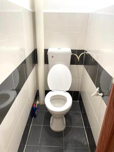 a bathroom with a white toilet and a sink at Cozy 288 Entire 3 bedroom House @ Alma Bukit Mertajam in Bukit Mertajam