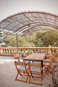 a table and chairs under an umbrella on a patio at Villa Tamaris in La Seyne-sur-Mer
