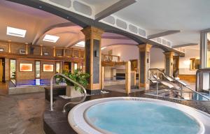 a large bathroom with a large tub in a building at Kristall- & Vitalhotel Bergknappenhof in Bodenmais