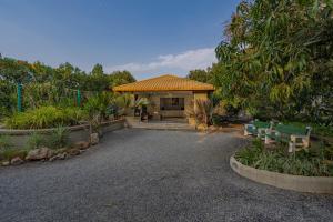 a house with a bench in front of it at Sterling Gir in Sasan Gir