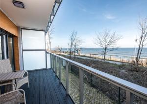a balcony with a view of the beach at Apartos Ustronie Apartments in Ustronie Morskie