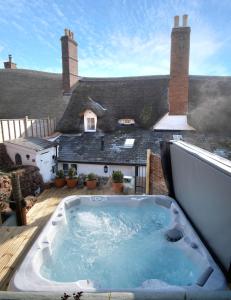 a hot tub on the deck of a house at The Old Sweet Shop in Minehead