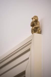 a statue of a frog sitting on top of a cabinet at The Gold Bank in Prague