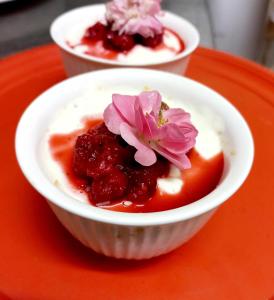 a white bowl of food with a flower on top at DeKotzenhof in Wakkerstroom