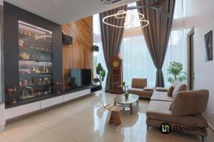 a living room with a couch and a tv at Private Pool Platinum House Melaka By I Housing in Melaka