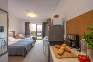 a hotel room with a bed and a table with food at RentPlanet - Apartamenty Okrzei in Szklarska Poręba