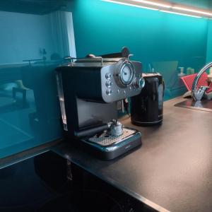 an old fashioned coffee maker sitting on a desk at Studio Four Seasons with parking place in Gdańsk