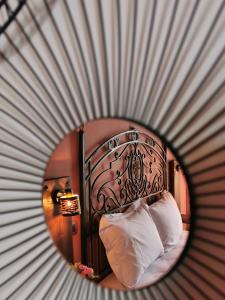a mirror reflection of a bed with white pillows at Terracotta Boutique Beach Studios in Mythimna