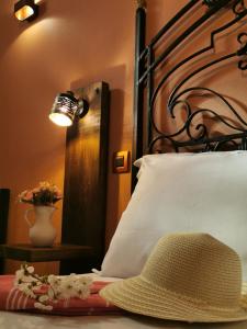 a bedroom with a bed with a hat on it at Terracotta Boutique Beach Studios in Mythimna
