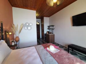a bedroom with a bed with a candle on it at Terracotta Boutique Beach Studios in Mythimna