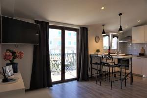 a kitchen and living room with a large sliding glass door at Apartment Cosy & Sweet in Makarska