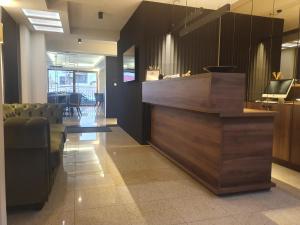 a lobby with a counter and chairs in a room at Pensiunea Mystique in Arad