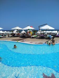 a group of people swimming in a swimming pool at Oasis Resort & Spa 2 floor with sea view Gen in Lozenets