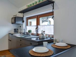 a kitchen with a counter with two plates on it at Willa Bartuś Baliczek in Bukowina Tatrzańska