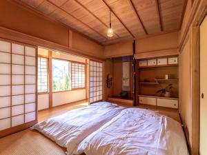 Postel nebo postele na pokoji v ubytování Guest House Takazuri-KITA
