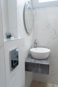 a white bathroom with a sink and a mirror at Dion Apartments in Lozenets +71 photos