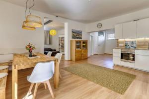 cocina y sala de estar con mesa y sillas en Das Bachhaus, en Drachselsried