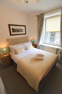 a bedroom with a large bed and a window at All Seasons Guest House in Windermere