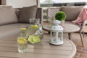 a table with glasses of water and lemon slices on it at Apartment Valy - Relaxing Terrace & Near Bled in Bled