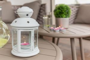 a lantern with a candle in it on a table at Apartment Valy - Relaxing Terrace & Near Bled in Bled +33 photos