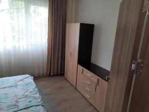 a bedroom with a flat screen tv and a bed at Sandanski city center apartment in Sandanski