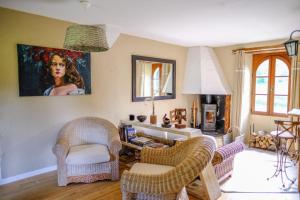 sala de estar con sillas de mimbre y chimenea en Bains de Secours, Chambres d'hotes en Sévignacq-Meyracq