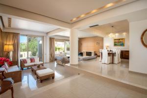 a large living room with couches and a table at Vasiliki Villa in Ialysos