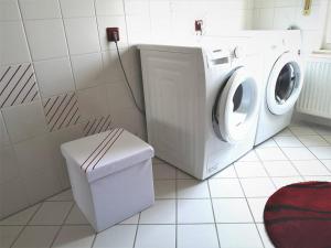 a washer and dryer in a bathroom with a washing machine at Ferienwohnung Maris in Burghaun