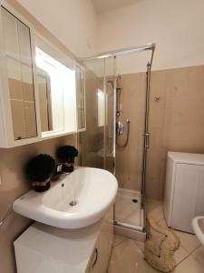 a white bathroom with a sink and a shower at Palace Britannique Love and magic in Bordighera in Bordighera +21 photos
