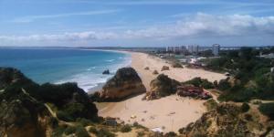 an aerial view of a beach with people on it at Alburvillage A - Apartamento Novo em Alvor in Alvor