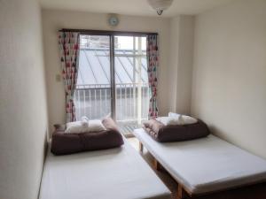 Postel nebo postele na pokoji v ubytování ゲストハウスTSUU小田原 Guest House Tsuu Odawara #OD1