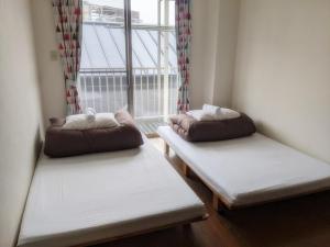 Postel nebo postele na pokoji v ubytování ゲストハウスTSUU小田原 Guest House Tsuu Odawara #OD1