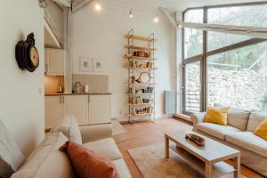 a living room with a couch and a table at Boutique apartments - Central Old Town in Banská Štiavnica