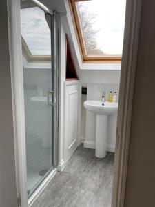 a bathroom with a sink and a glass shower at Wynards Farm in Winfrith Newburgh