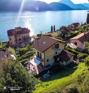 an aerial view of a house on the shore of a lake at B&B-FORESTERIA Casa Della Musica Lake Como in Mandello del Lario