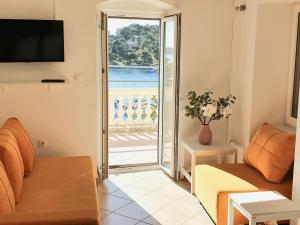 a living room with a couch and a view of the ocean at Holiday Home Meditation in Hvar