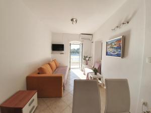 a living room with a couch and a table at Holiday Home Meditation in Hvar