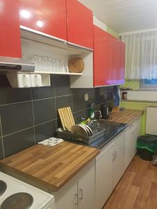 a kitchen with red cabinets and a wooden counter top at Wohnung Bornstraße in Freigericht