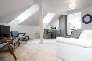 a living room with a white couch and a table at Bryan Street Apartments in Ballymena
