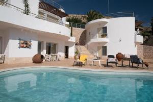 a villa with a swimming pool in front of a house at Beach Park Apartments in Luz +11 photos